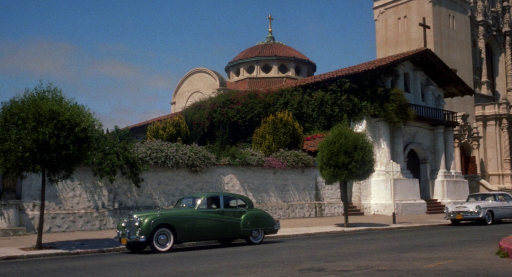 Kim Novak's green car parked outside a white mission with red roof. Color palettes